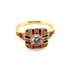 AN 18ct HALLMARKED GOLD DIAMOND AND FANCY CUT RUBY ART DECO STYLE RING. THE CENTRAL DIAMOND DIAMETER