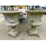 A PAIR OF COMPOSITE CLASSICAL STYLE GARDEN URNS