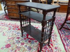 AN ARTS AND CRAFTS LIBERTYS STYLE OAK THREE SHELF STAND, WOOD GRILLES JOINING THE RING TURNED