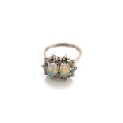 AN 18ct HALLMARKED WHITE GOLD OPAL AND DIAMOND DOUBLE CLUSTER RING, THE TWO OVAL OPALS IN CLAW