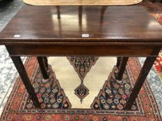 A GEORGE III MAHOGANY TEA TABLE OPENING ON A SINGLE GATE, THE SQUARE SECTIONED LEGS CARVED WITH