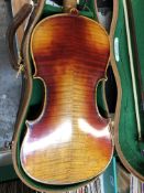 A CANVAS CASED STRADIVARIUS STYLE VIOLIN TOGETHER WITH TWO BOWS, THE BACK OF THE VIOLIN TO THE NECK.