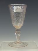 AN 18th C. BOHEMIAN WINE GLASS, THE BOWL ENGRAVED WITH A CROWNED MONOGRAM BETWEEN FRUITING LEAVES,