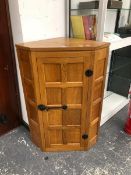 A ROBERT MOUSEMAN THOMPSON OAK CORNER CUPBOARD, THE EIGHT PANELLED DOOR FLANKED BY FOUR FURTHER