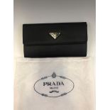 A BLACK PRADA PURSE COMPLETE WITH DUST BAG, WITH LEATHER INTERIOR AND ORIGINAL CERTIFICATE OF