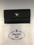 A BLACK PRADA PURSE COMPLETE WITH DUST BAG, WITH LEATHER INTERIOR AND ORIGINAL CERTIFICATE OF