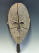 AN EARLY 20th C. SENUFO BAOBAB ZEBRA SUN DANCE MASK, THE HAND HELD MASK GOUGED OVERALL WITH WHITENED