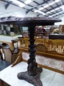 AN ANTIQUE ORIENTAL HARDWOOD TABLE WITH FLORAL CARVED EDGE TO THE TOP AND ON A PROFUSELY CARVED