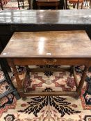 AN 18th C. OAK SIDE TABLE WITH SINGLE DRAWER ABOVE GUN BARREL LEGS JOINED BY STRETCHERS ABOVE THE