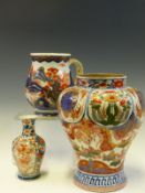 A CHINESE IMARI BALUSTER PINT MUG PAINTED WITH ISLANDS, A JAPANESE IMARI VASE AND ANOTHER LARGER.