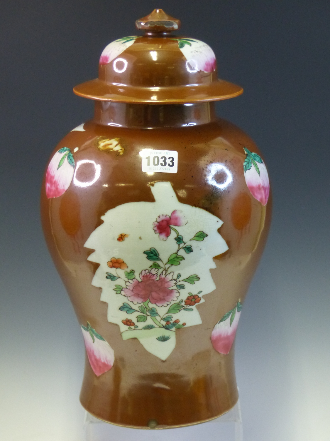 A CHINESE BALUSTER VASE AND COVER PAINTED IN FAMILLE ROSE ENAMELS WITH PEACHES AND LEAF SHAPED