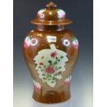 A CHINESE BALUSTER VASE AND COVER PAINTED IN FAMILLE ROSE ENAMELS WITH PEACHES AND LEAF SHAPED