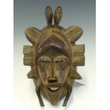 A MAHOGANY MASK, LATE 19th C. ZAIRE, PIERCED WITH EYES AND MOUTH AND FRAMED BY PROJECTING FLAPS, TWO