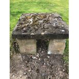 A SQUARE BOWED STONE BLOCK ON FOUR STONE SUPPORTS 76cms SQUARE HEIGHT 43cms, TOGETHER WITH ANOTHER