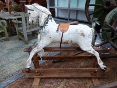 A VINTAGE WHITE PAINTED ROCKING HORSE WITH LEATHER SADDLE AND EASTERN COIN NECKLACE REINS- (