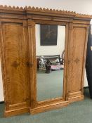 A CARVED AND INLAID SATINBIRCH AESTHETIC STYLE VICTORIAN TRIPLE WARDROBE BY HEAL AND SON LONDON.