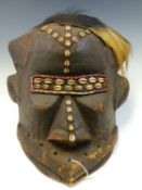 A LATE 19th C. GABONESE HUNTERS DANCE BAOBAB MASK DECORATED WITH BEADS AND COWRIE SHELLS, THE HAIR