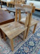 A SET OF FOUR RUSTIC OAK CHAIRS, THE BAR TOP RAILS ABOVE SOLID SEATS AND TAPERING SQUARE SECTIONED