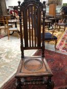 A SET OF TEN WILLIAM AND MARY STYLE ANTIQUE OAK CHAIRS, THE ROUND ARCH TOP RAILS CARVED WITH C-