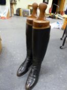 A PAIR OF VINTAGE BLACK LEATHER RIDING BOOTS WITH WOODEN TREES.