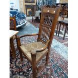 AN UNUSUAL SET OF SEVEN ANTIQUE CARVED OAK GOTHIC REVIVAL DINING CHAIRS WITH RUSH SEATS, INCLUDES