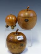 TWO APPLE SHAPED TEA CADDIES TOGETHER WITH A SPHERICAL BURR WOOD SCREW TOPPED STRING DISPENSER ON