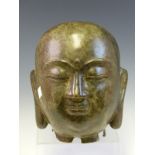 A BRONZE HEAD OF THE BUDDHA, HIS SERENE FACE WITH A THIRD EYE OR URNA ON HIS FOREHEAD. H 21cms.