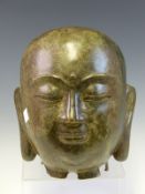 A BRONZE HEAD OF THE BUDDHA, HIS SERENE FACE WITH A THIRD EYE OR URNA ON HIS FOREHEAD. H 21cms.