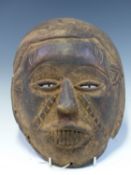 A 19th C. DAN BAOBAB WOODEN MASK, ITS BARED TEETH SIGNIFYING A RECENT DEATH. H 28cms.
