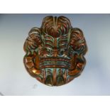 A COPPER JELLY MOULD TOPPED BY THE PRINCE OF WALES FEATHERS, THE MOUTH. Dia. 14cms.