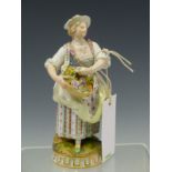 A MEISSEN FIGURE OF A LADY STANDING HOLDING A BASKET OF FLOWERS, HER HAT AND CLOTHES TRIMMED WITH