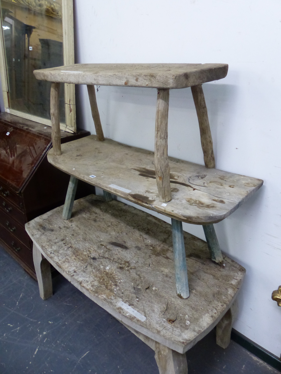 THREE WEATHERED RUSTIC WOOD TABLES, EACH ON FOUR LEGS, THE LARGEST. W 126 x D 69 x H 59cms.