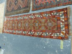 AN ANTIQUE PERSIAN TRIBAL RUNNER 286 x 83 cms