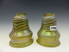 A PAIR OF GREEN IRIDESCENT GLASS LIGHT SHADES TRAILED HORIZONTALLY IN WHITE. H 16.5cms.