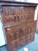 AN 18th C. OAK DEUDDARN, THE TOP WITH THREE DOORS EACH OF FOUR PANELS, THE BASE WITH THREE DRAWERS