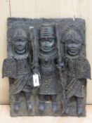 A BENIN BRONZE PLAQUE CAST IN HIGH RELIEF WITH TWO SOLDIERS WITH SHIELDS FLANKING AND GUARDING A