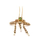 AN ANTIQUE ART NOUVEAU PERIDOT AND SEED PEAR PENDANT SUSPENDED ON A FIGARO CHAIN WITH BARREL