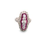 A RUBY AND DIAMOND ART DECO STYLE PANEL RING. FIVE OLD CUT GRADUATED DIAMONDS SURROUNDED BY A