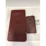 A CARTIER GLASSES CASE TOGETHER WITH A KEY WALLET