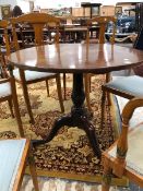 A GEORGE III MAHOGANY TILT TOP TRIPOD TABLE, THE BASE OF THE GUN BARREL COLUMN SPIRALLY TURNED,