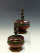 A PAIR OF AFRICAN PAINTED TURNED WOOD BOWLS WITH COUCHING FIGURE COVER FINIALS, Dia. 13cms.