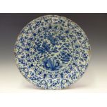 AN 18th C. DELFT BLUE AND DISH PAINTED WITH FLOWERS WITHIN IN TWO RIMS BANDS OF FURTHER FLOWERS.