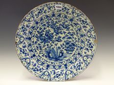 AN 18th C. DELFT BLUE AND DISH PAINTED WITH FLOWERS WITHIN IN TWO RIMS BANDS OF FURTHER FLOWERS.