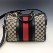 A NAVY AND RED STRIPE GUCCI CANVAS BOSTON BAG, COMPLETE WITH ORIGINAL PURCHASERS RECEIPT AND DUST
