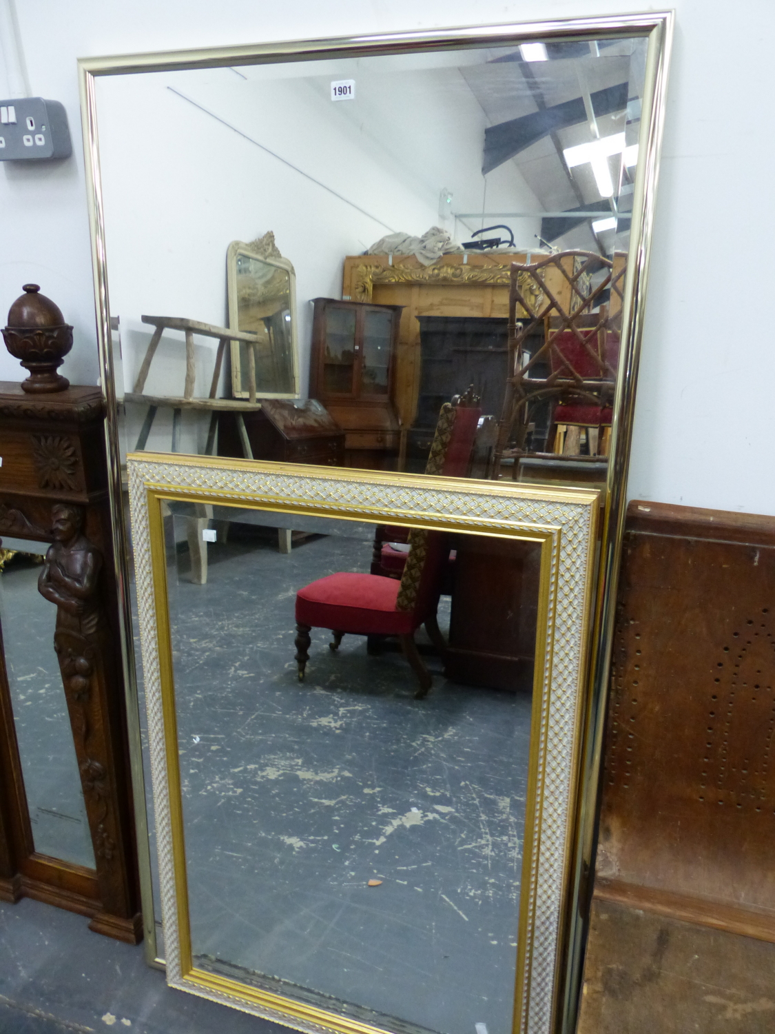 TWO RECTANGULAR BEVELLED GLASS MIRRORS, ONE IN A GILT FRAME AND THE LARGER IN A BRASS FRAME. 157 x