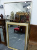 TWO RECTANGULAR BEVELLED GLASS MIRRORS, ONE IN A GILT FRAME AND THE LARGER IN A BRASS FRAME. 157 x