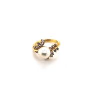 A CULTURED PEARL AND DIAMOND BYPASS RING. PEARL MEASUREMENT 8.3mm. UNHALLMARKED, STAMPED 750,