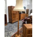 A ROBERT MOUSEMAN THOMPSON OAK STANDARD LAMP, THE OCTAGONAL COLUMN FLARING TO A STEPPED FOOT.