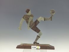 AN ART DECO CHROME FOOTBALLER DETAILED IN BLACK KICKING UP THE BALL WITH ONE FOOT RAISED, THE BASE