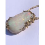 AN EXCEPTIONAL LARGE OPAL AND DIAMOND PENDANT, THE OVAL FORM OPAL MOUNTED IN A 14ct GOLD AND DIAMOND